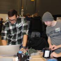 4 seniors looking at their project on a table